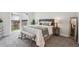 Bright bedroom features a walkout to a patio, with a gray and white bed, side table and full length mirror at 17634 E Ohio Cir, Aurora, CO 80017