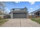 Two-story home featuring neutral siding, a two car garage, and a concrete driveway at 17634 E Ohio Cir, Aurora, CO 80017