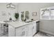 Modern kitchen featuring a spacious island with stainless steel sink, and white cabinets at 17634 E Ohio Cir, Aurora, CO 80017