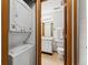 Cozy bathroom featuring a white vanity, a toilet and shower, and an in-unit washer and dryer at 8424 Everett Way # E, Arvada, CO 80005