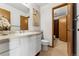Cozy bathroom with a single vanity, toilet, and doorway to walk-in shower at 8424 Everett Way # E, Arvada, CO 80005