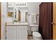 Bathroom with white vanity, tile floors, toilet and tub/shower combo at 8424 Everett Way # E, Arvada, CO 80005