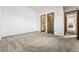 A clean bedroom with ensuite bathroom, with neutral carpet and white walls at 8424 Everett Way # E, Arvada, CO 80005