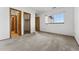A cozy bedroom with two closets and natural light streaming through a large window at 8424 Everett Way # E, Arvada, CO 80005