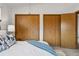 Bedroom featuring a large closet, and a cozy bed with a blue throw at 8424 Everett Way # E, Arvada, CO 80005
