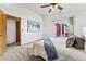 Bedroom featuring sliding glass doors, ceiling fan, and a scenic deck view at 8424 Everett Way # E, Arvada, CO 80005