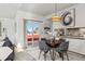 Cozy dining room featuring modern decor, seating for four, and a sliding door at 8424 Everett Way # E, Arvada, CO 80005