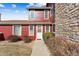 Townhouse exterior features a stone chimney and tidy landscaping at 8424 Everett Way # E, Arvada, CO 80005