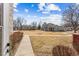 Charming condo community with well-maintained lawns, mature trees, and walking path under a bright, cloudy sky at 8424 Everett Way # E, Arvada, CO 80005