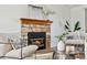 Bright living room featuring a stone fireplace, stylish decor, and comfortable seating at 8424 Everett Way # E, Arvada, CO 80005