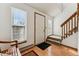 Bright foyer with hardwood floors, staircase, and ample natural light from the large window at 8424 Everett Way # E, Arvada, CO 80005
