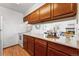 Kitchen area with white appliances and warm wood cabinets featuring a pass through to the dining area at 8424 Everett Way # E, Arvada, CO 80005