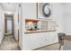 Hallway featuring a peek-through into a bright kitchen with modern appliances and decor at 8424 Everett Way # E, Arvada, CO 80005