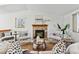 Inviting living room with a stone fireplace, cozy seating, and bright natural light at 8424 Everett Way # E, Arvada, CO 80005