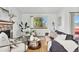 Bright living room featuring a stone fireplace, neutral decor, and a large window at 8424 Everett Way # E, Arvada, CO 80005