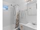 Bright bathroom features a shower and tub combo with white tile at 1740 Trenton St, Denver, CO 80220