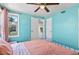 Spacious light blue bedroom with a ceiling fan and large closet at 1740 Trenton St, Denver, CO 80220