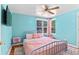 Bright and airy blue bedroom with stylish furnishings, ceiling fan, and natural light at 1740 Trenton St, Denver, CO 80220