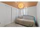 Charming bedroom featuring unique ceiling, stylish lighting and closet with sliding doors at 1740 Trenton St, Denver, CO 80220
