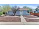 Charming single-story home with light blue siding and tidy landscaping enhancing curb appeal at 1740 Trenton St, Denver, CO 80220