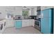 Modern kitchen featuring white cabinetry, stainless steel appliances, and colorful retro accents at 1740 Trenton St, Denver, CO 80220