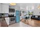 Bright kitchen featuring white cabinets, stainless appliances, and a unique blue refrigerator at 1740 Trenton St, Denver, CO 80220