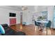 Open-concept living area with hardwood floors, modern decor, and an adjoining kitchen at 1740 Trenton St, Denver, CO 80220