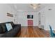 Well-lit living space with hardwood floors, modern decor, and a view to the entry door at 1740 Trenton St, Denver, CO 80220