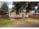 A charming brick home is enhanced with a well-manicured lawn and lush landscaping at 2644 N Glencoe St, Denver, CO 80207
