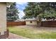 Expansive backyard featuring lush green lawn, rock landscaping, and a wood privacy fence at 2644 N Glencoe St, Denver, CO 80207