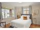 Cozy bedroom with hardwood floors, soft lighting, and views of the neighborhood at 2644 N Glencoe St, Denver, CO 80207