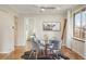 Cozy dining area with hardwood floors, modern lighting, and a view into the adjacent living space at 2644 N Glencoe St, Denver, CO 80207