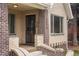 Inviting entryway with brick pillars, a secure front door, and a glimpse of the interior at 2644 N Glencoe St, Denver, CO 80207