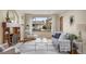 Cozy living room featuring a fireplace, hardwood floors, and a large window with natural light at 2644 N Glencoe St, Denver, CO 80207