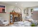 Comfortable living room with a brick fireplace, built-in shelving, and stylish furnishings at 2644 N Glencoe St, Denver, CO 80207