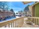 Balcony view overlooking snow-covered landscape, showcasing the community's winter charm and serene surroundings under a blue sky at 2800 Kalmia Ave # B209, Boulder, CO 80301