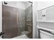 Close-up of a modern glass-enclosed shower and toilet with storage space for a streamlined design at 2800 Kalmia Ave # B209, Boulder, CO 80301