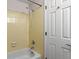 A simple bathroom with a white shower/bathtub combo and yellow tile at 2800 Kalmia Ave # B209, Boulder, CO 80301