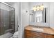 This bathroom features a wood vanity, granite top, glass enclosed shower, and modern fixtures at 2800 Kalmia Ave # B209, Boulder, CO 80301