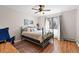 This bedroom features hardwood floors, a ceiling fan, and a large window for natural light at 2800 Kalmia Ave # B209, Boulder, CO 80301