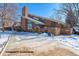 Exterior view of the community clubhouse highlighting its architectural design, inviting space, and landscaping during winter at 2800 Kalmia Ave # B209, Boulder, CO 80301