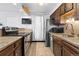 Galley kitchen featuring stainless steel appliances, granite countertops, and tile backsplash at 2800 Kalmia Ave # B209, Boulder, CO 80301