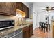 Kitchen area with stainless steel appliances, granite countertops, and an adjacent dining area at 2800 Kalmia Ave # B209, Boulder, CO 80301