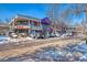 Retail building exterior with stores and parking, highlighting shopping and dining convenience in the community, winter scene with snow at 2800 Kalmia Ave # B209, Boulder, CO 80301