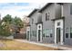 Modern townhomes feature gray stucco exteriors with white trim and dark green doors at 5810 W 39Th Pl, Wheat Ridge, CO 80212
