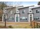 Contemporary townhome exterior showcases gray stucco, white trim, and a well-kept lawn at 5810 W 39Th Pl, Wheat Ridge, CO 80212