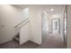 Bright hallway with staircase and access to rooms with modern doors and carpeted floors at 5810 W 39Th Pl, Wheat Ridge, CO 80212