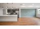 Open-concept living area features modern kitchen with stainless steel appliances and island at 5810 W 39Th Pl, Wheat Ridge, CO 80212