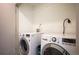 A practical laundry room featuring a modern washer and dryer at 5810 W 39Th Pl, Wheat Ridge, CO 80212