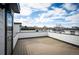 A rooftop deck offers city views, modern railings and wood-look flooring at 5810 W 39Th Pl, Wheat Ridge, CO 80212